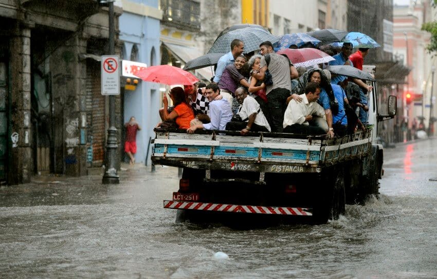 Grupo escapa de área alagada no Rio em caçamba de caminhão durante temporal. Foto: Fernando Frazão/ Agência Brasil (29/02/2016)